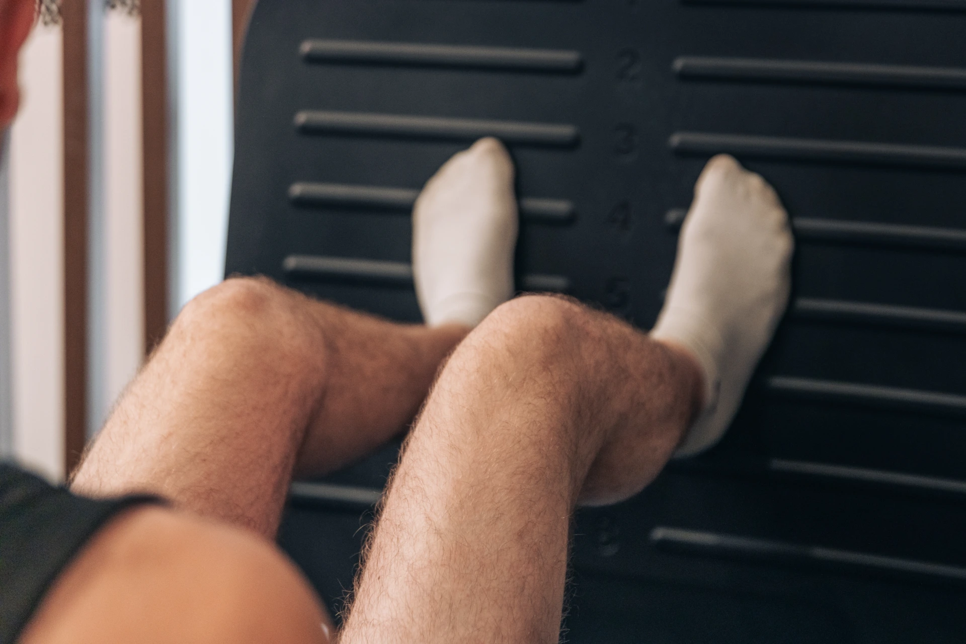 A patient's legs extended on a leg press