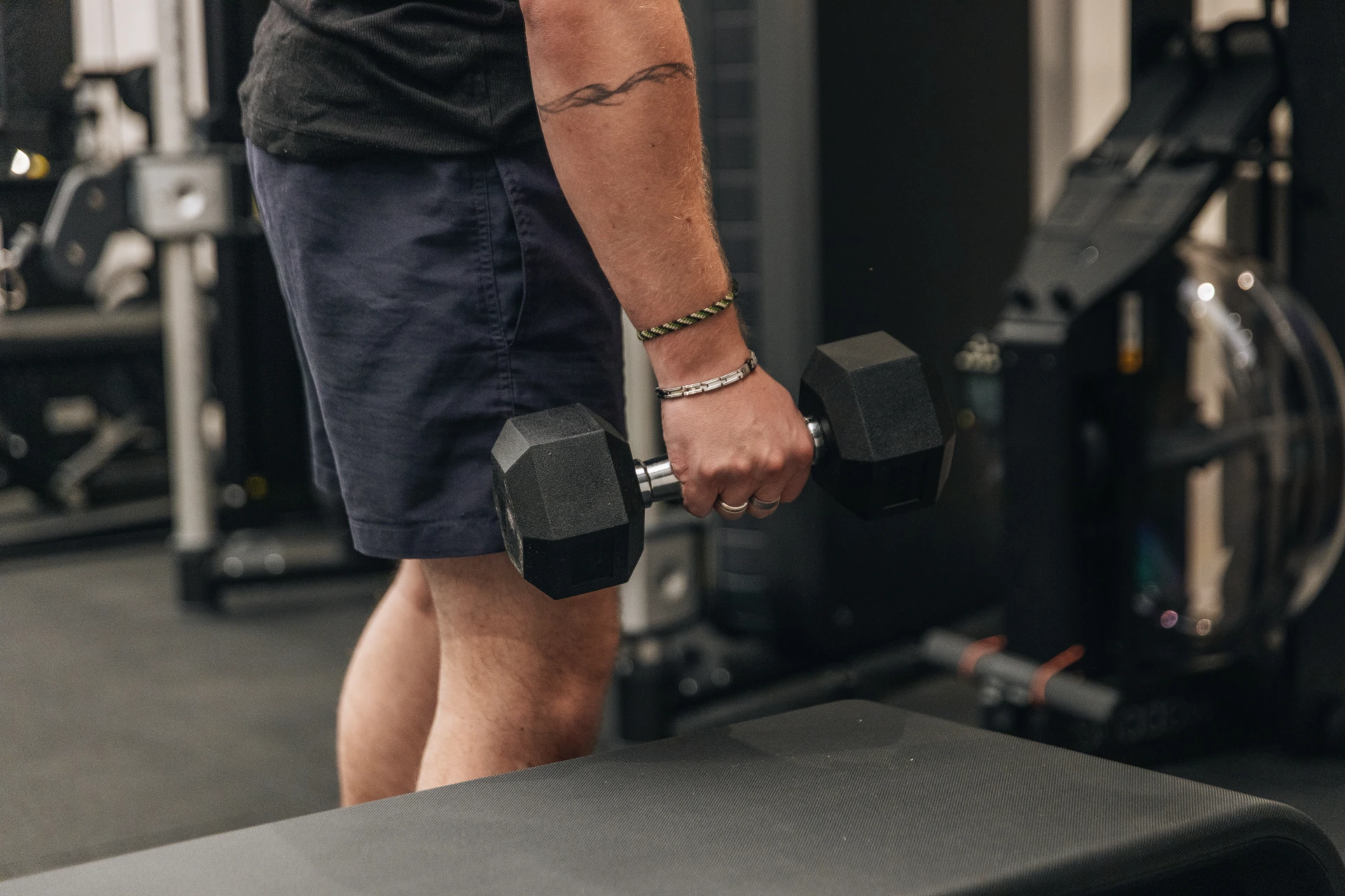 Patient standing holding a dumbbell in the rehabilitation room